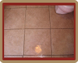 Bathroom tile floor with heavily soiled grout.